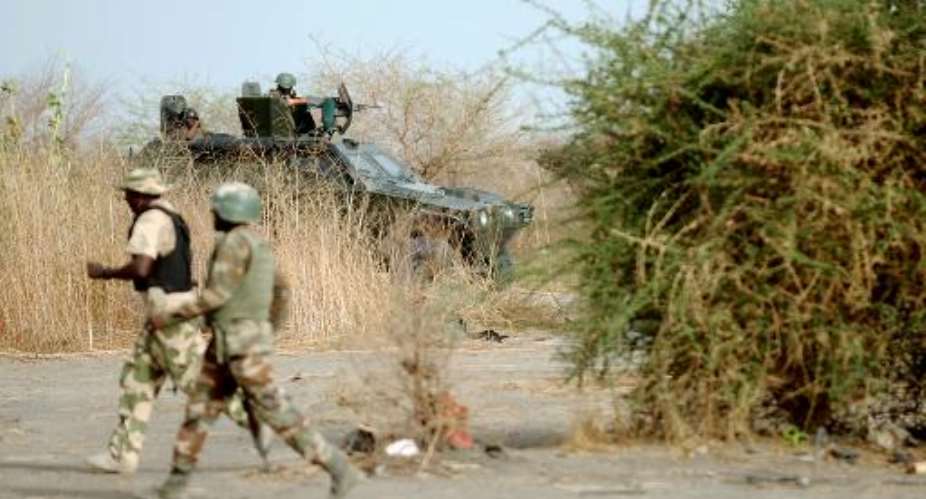 This picture taken on June 5, 2013 shows Nigerian soldiers patrolling in Maiduguri.  By Quentin Leboucher AFPFile