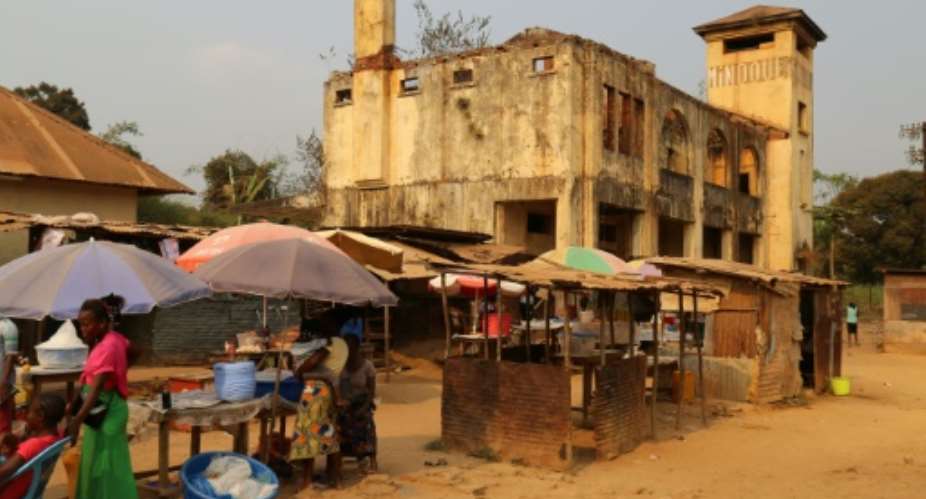 Outside Mindouli's war-battered railway station, a relic of French colonial times, a few hawkers set up stalls in the hope of snaring a little cash.  By SAMIR TOUNSI AFP