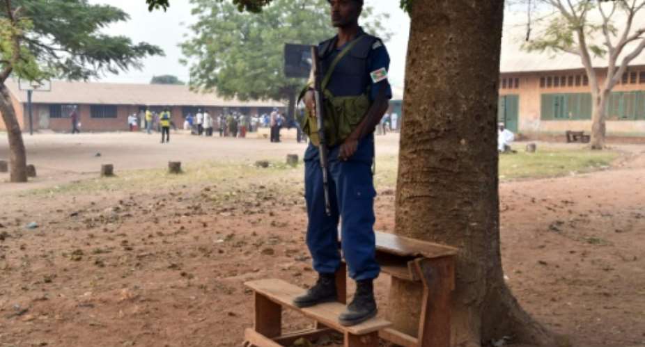 A Burundi UN peacekeeper watches at the entrance to a polling station on December 30, 2015.  By Issouf Sanogo AFP