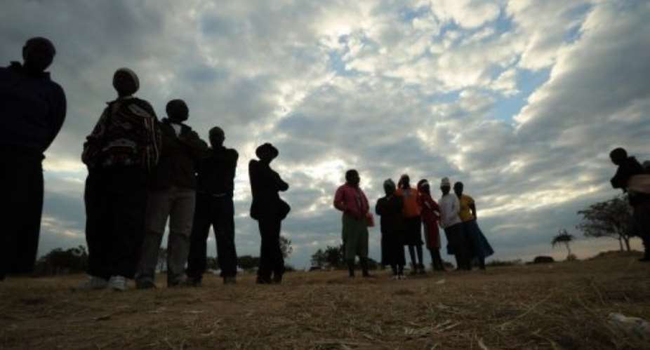 Zimbabweans prepare to cast their ballots at a polling station in Domboshava on July 31, 2013.  By Alexander Joe AFPFile