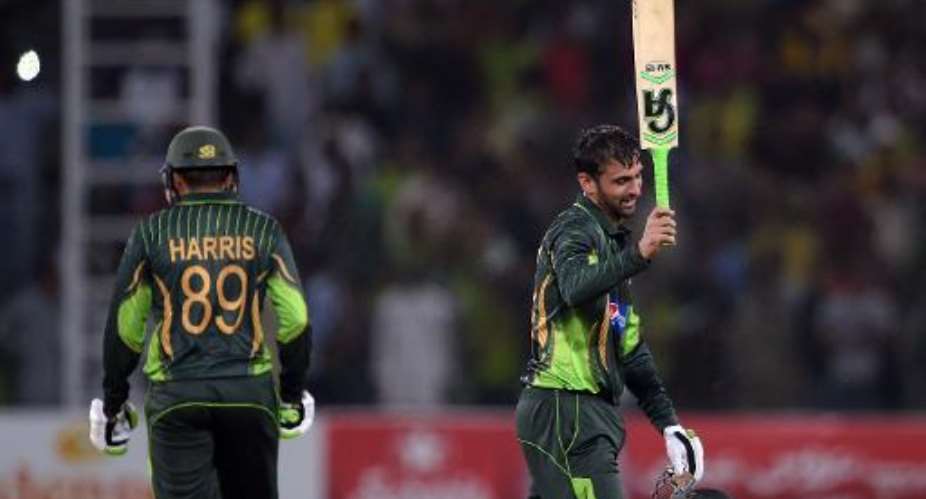 Pakistan's Shoaib Malik celebrates after reaching his century against Zimbabwe on May 26, 2015.  By Aamir Qureshi AFP