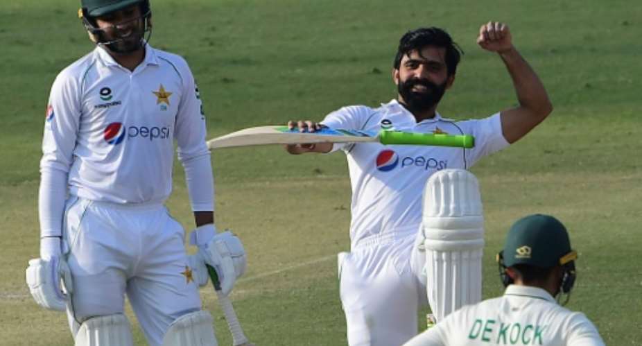 Pakistan's Fawad Alam celebrates after reaching his century while teammate Faheem Ashraf looks on.  By Asif HASSAN AFP