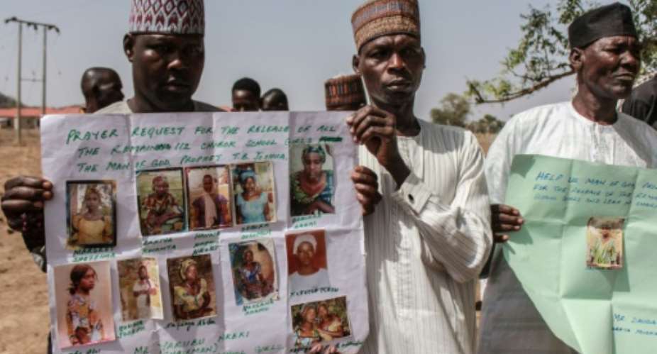 Parents and relatives hold portraits of their girls during a commemoration five years after they were abducted by Boko Haram Jihadists who stormed the Chibok girls' boarding school.  By Audu Ali MARTE AFPFile