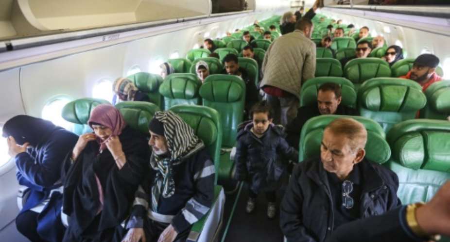 Passengers board and sit inside an aircraft at Mitiga airport, east of the Libyan capital Tripoli.  By Mahmud TURKIA AFP