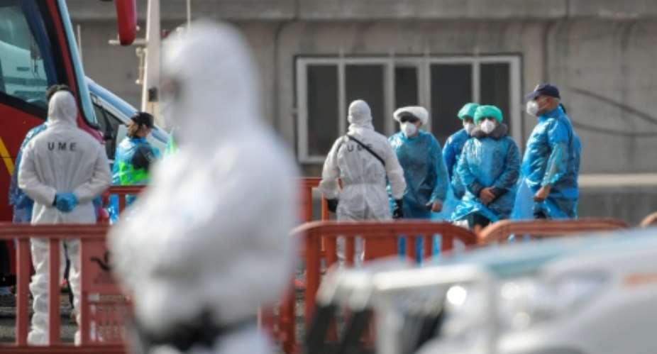 Passengers wearing blue protective suits were evacuated from the cruise ship MV Hondius at the industrial port of Granadilla de Abona on the island of Tenerife in Spains Canary Islands.  By JORGE GUERRERO (AFP)