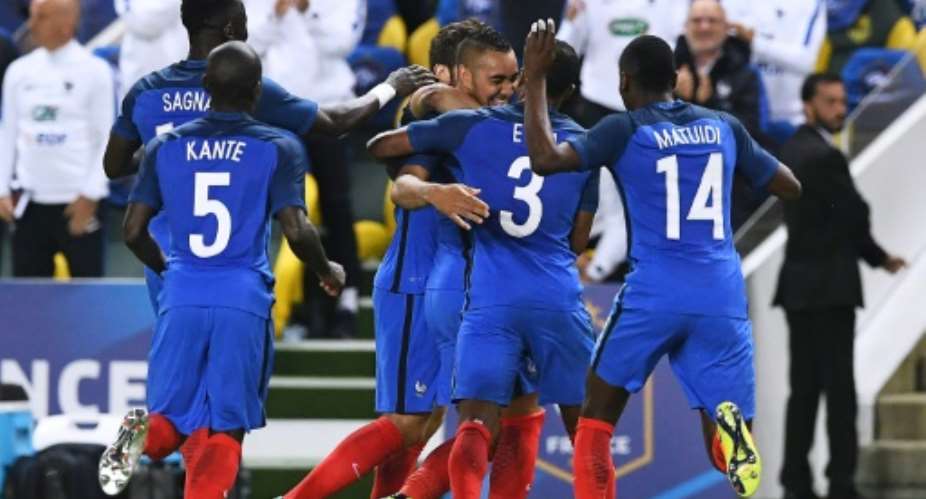 France's forward Dimitri Payet C is congratuled by teammates after scoring a goal  during the friendly football match between France and Cameroon, at the Beaujoire Stadium in Nantes, western France, on May 30, 2016.  By Franck Fife AFP