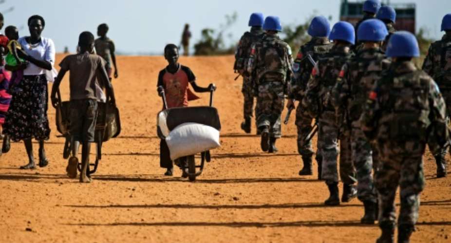 Peacekeeper troops deployed by the United Nations Mission in South Sudan UNMISS, patrol on foot outside the premises of the UN Protection of Civilians PoC site in Juba, South Sudan, on October 4, 2016.  By Albert Gonzalez Farran AFPFile