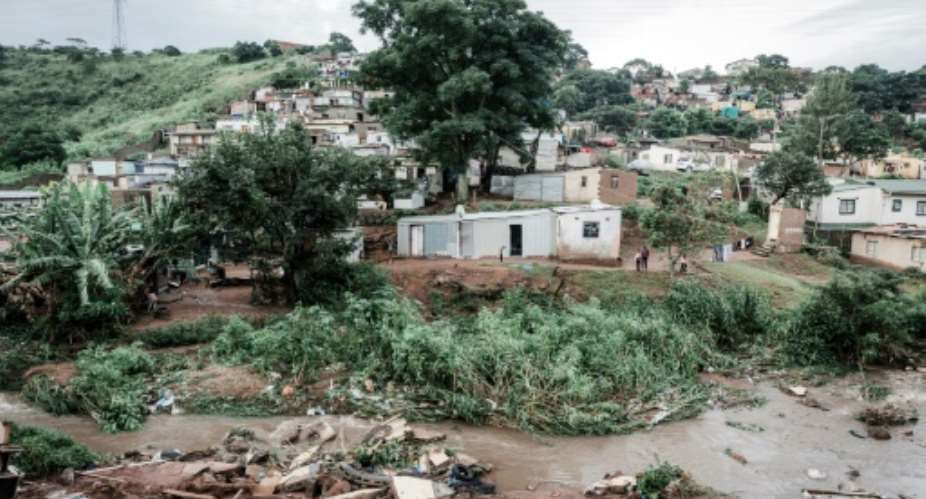 People abandon their homes at an informal settlement of BottleBrush, south of Durban, after torrential rains and flash floods destroyed their homes.  By RAJESH JANTILAL AFP
