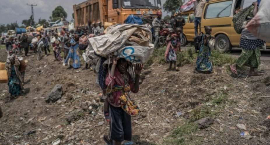 People fleeing earlier fighting in eastern DR Congo with whatever they can carry on February 8.  By Aubin Mukoni AFPFile