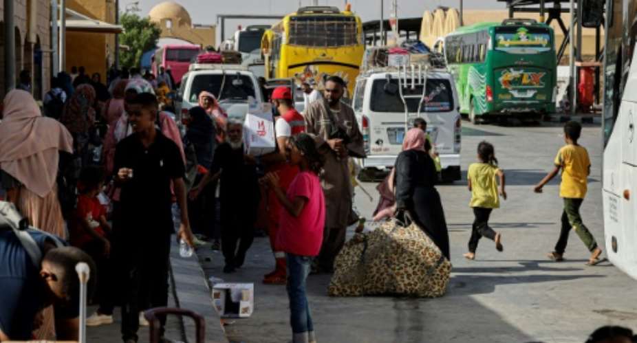 People fleeing war-torn Sudan arrive at Qastal land port crossing to Egypt in May last year.  The UN says Egypt is home to more than 845,000 registered refugees and asylum seekers from Sudan.  By Khaled DESOUKI (AFP/File)
