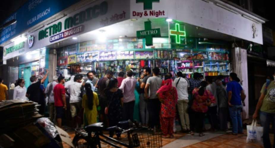People gather at a pharmacy in Mumbai following the Indian prime minister's announcement of a government-imposed nationwide lockdown.  By Indranil MUKHERJEE AFP