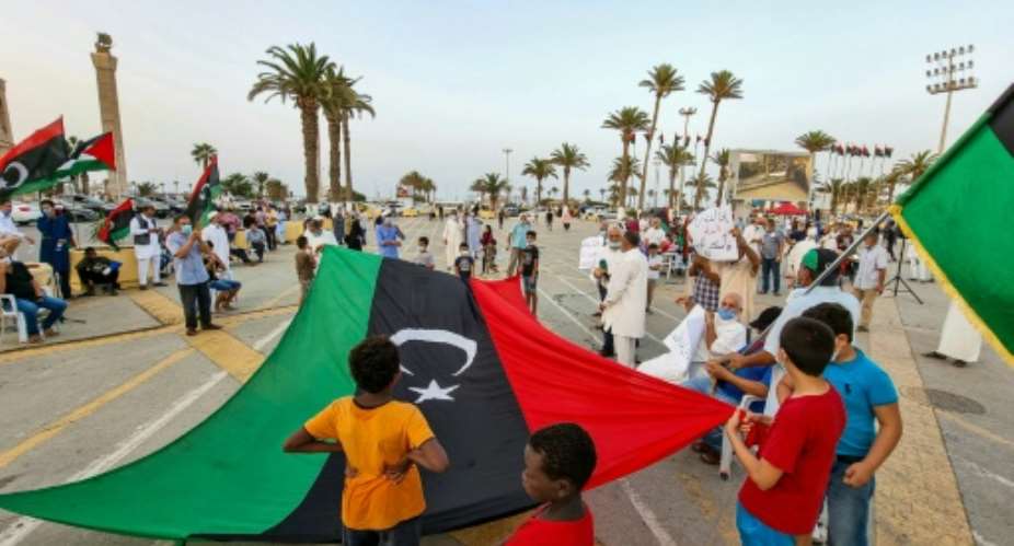 People gather with Libyan national flags at the Martyrs' Square in the centre of Tripoli on August 20, to mark the 10th anniversary of the city's capture from the forces of former leader Moamer Kadhafi.  By Mahmud TURKIA AFPFile
