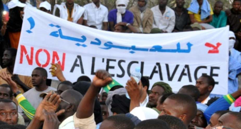 People hold a banner reading No to slavery during a 2015 demonstration in Nouakchott.  By - (AFP)