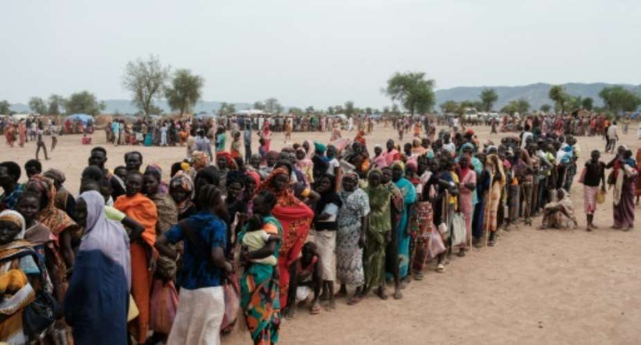 People line up to register for potential food aid delivery at a camp for internally displaced persons in Agari, South Kordofan, on June 17, 2024.  By GUY PETERSON (AFP/File)