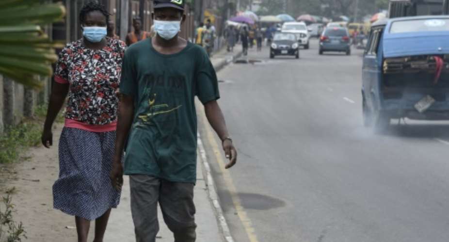 People scrambled to buy face masks and hand sanitiser in Lagos after sub-Saharan Africa's first case of coronavirus was detected.  By PIUS UTOMI EKPEI AFP