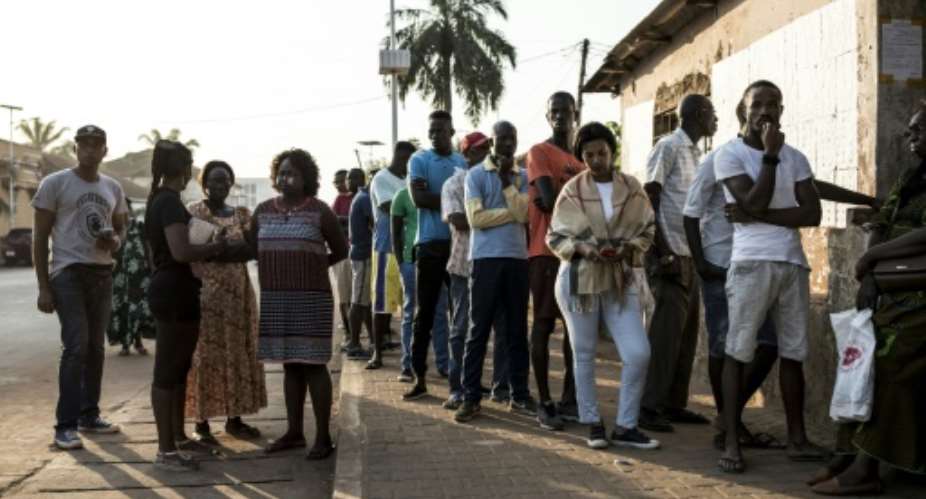People wait to cast their vote in Bissau, the capital.  By JOHN WESSELS AFP