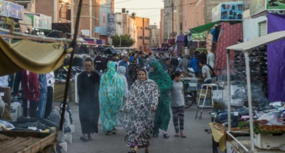 People walk along a market street in Western Sahara's main city of Laayoune in November 2018.  By FADEL SENNA AFPFile