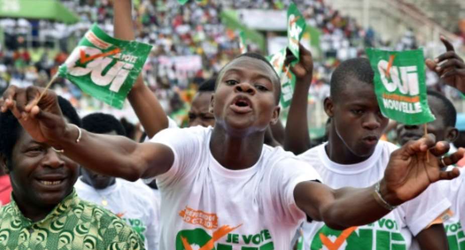 People with placards reading 'Referendum October 30, 2016 - I vote yes' cheer during a rally organised by Ivory Coast's president Alassane Ouattara, at the Felix Houphouet-Boigny stadium in Abidjan, on October 22, 2016.  By Issouf Sanogo AFPFile