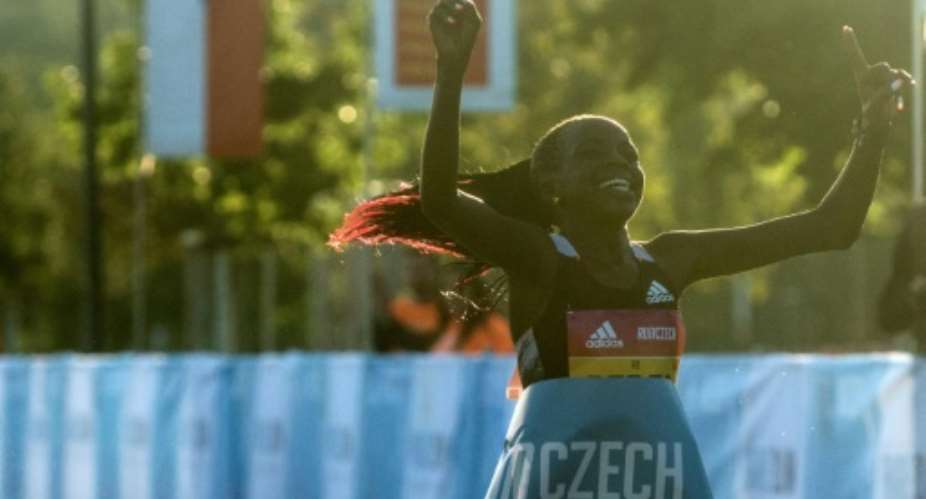 Peres Jepchirchir of Kenya crosses the finish line to win the women-only half marathon in a new record time.  By Michal Cizek AFP