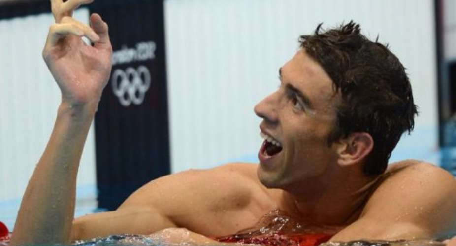 US swimmer Michael Phelps celebrates at the end of the mens 4x200m freestyle relay final.  By Christophe Simon (AFP)