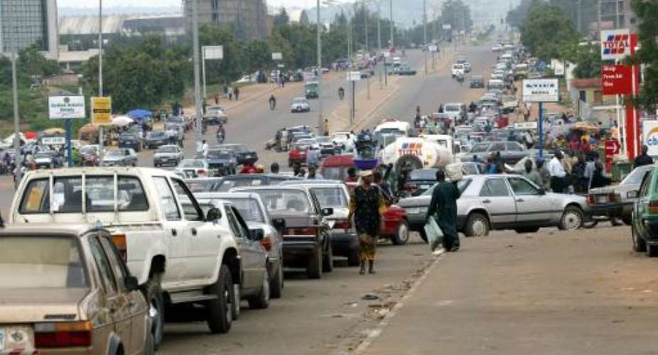 Motorists rush to buy petrol in Abuja  during an earlier fuel shortage.  By Pius Utomi Ekpei AFP