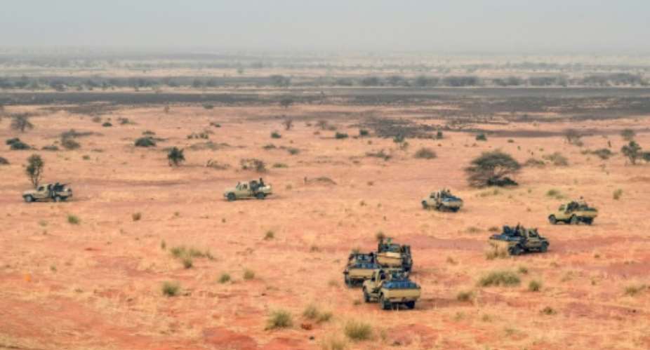 Pick-up trucks belonging to militants of MSA patrol along the Mali-Niger border in the deserted area of the Menaka region in Mali on February 4, 2018.  By Souleymane AG ANARA (AFP/File)