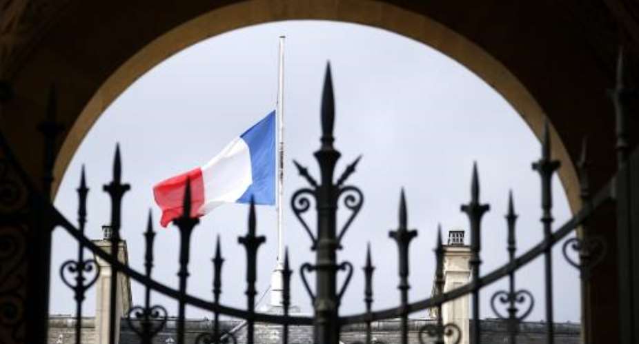 A French flag flies half-mast at the Elysee Palace in Paris on July 28, 2014. France on July 26 said flags on every public building would fly at half-mast for three days from July 28 to mourn the Air Algerie crash in Mali.  By Kenzo Tribouillard AFP
