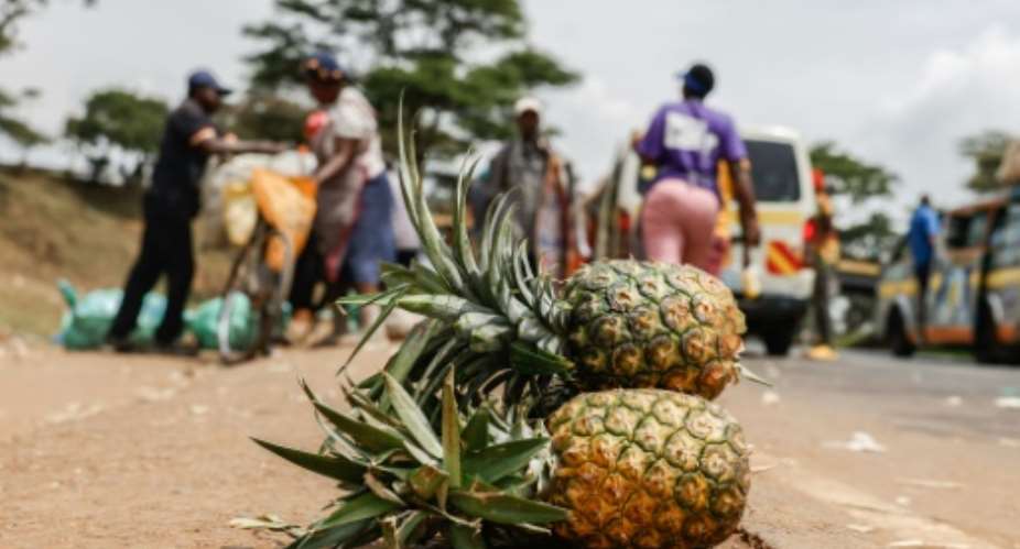 Pineapples at an informal market on the road in Kenya.  By SIMON MAINA AFP