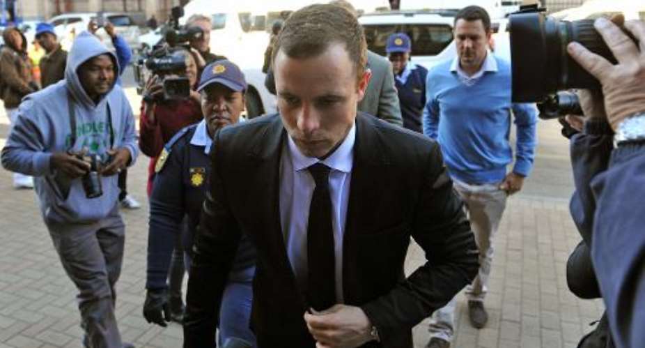 South African paralympian athlete Oscar Pistorius arrives on July 7, 2014 for his murder trial at the High Court in Pretoria.  By Antoine de Ras POOLAFP