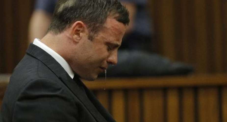 South African paralympic athlete Oscar Pistorius cries as the judge reads out the verdict during his murder trial in Pretoria, on September 11, 2014.  By Kim Ludbrook PoolAFP