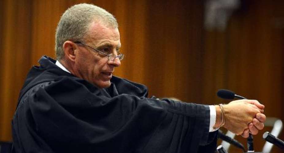 Chief prosecutor in the murder trial of South African Olympic and Paralympic sprinter Oscar Pistorius, Gerrie Nel, gestures during cross-examination at the high court in Pretoria, on April 14, 2014.  By Antoine de Ras PoolAFPFile
