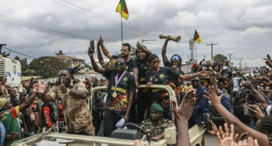 Players from Cameroons victorious WAFCON team wave to the crowds in Yaounde.  By Daniel BELOUMOU OLOMO (AFP)