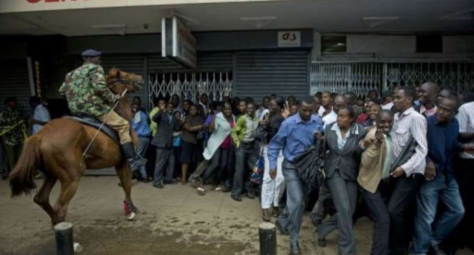 A policeman on a horse tries to control a crowd after a blast in central Nairobi on Moi Avenue.  By Tony Karumba AFP