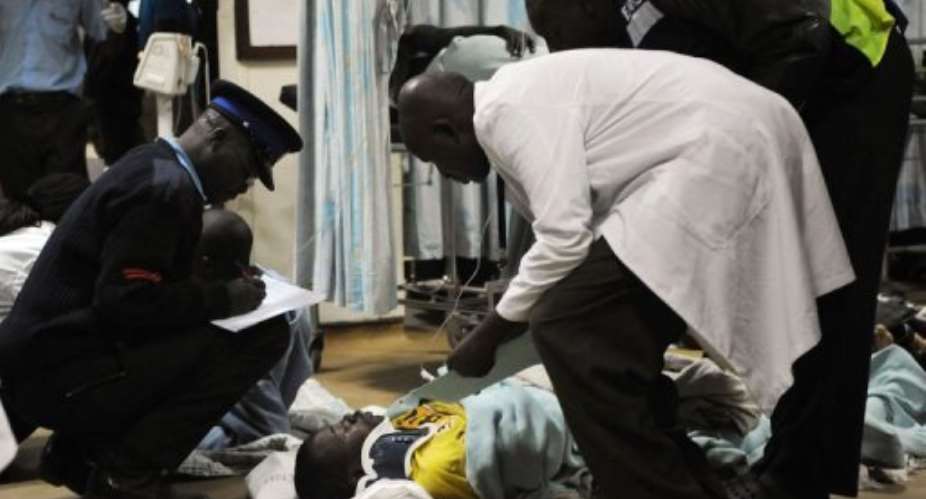 A man is assisted into the hospital in Nairobi.  By Simon Maina AFP