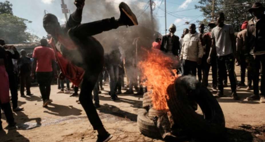 Police clashed with stone-throwing demonstrators in Nairobi's largest slum Kibera.  By YASUYOSHI CHIBA AFP