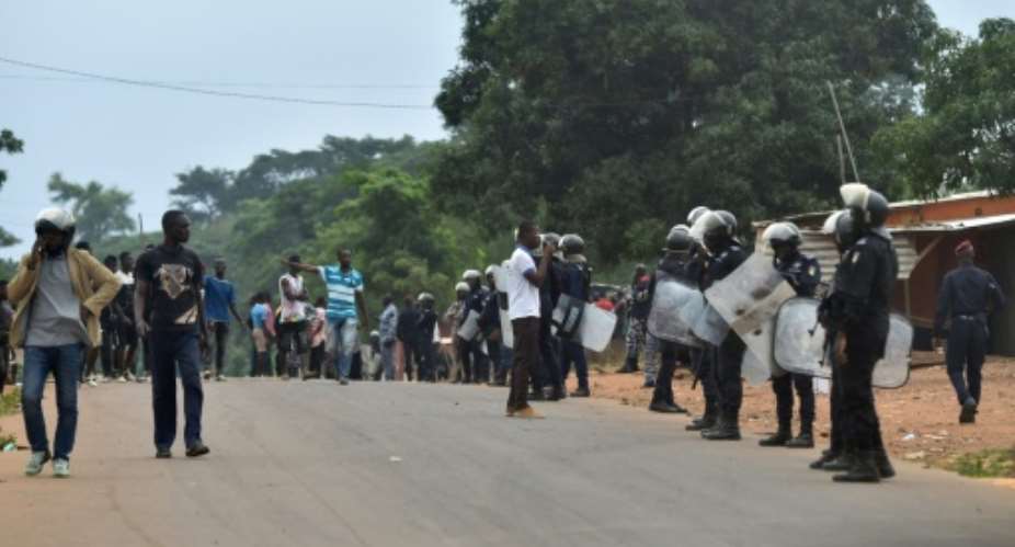 Police in Daoukro set up a buffer zone after clashes between ethnic groups sparked by President Alassane Ouattara's decision to run again.  By SIA KAMBOU AFP