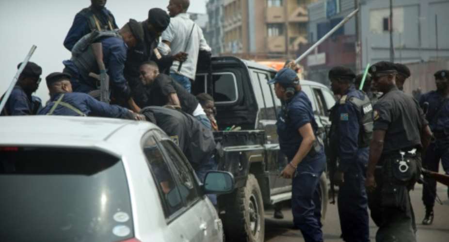 Police officers clash with protesters during a Kinshasa rally to mark the 59th anniversary of DR Congo's independence.  By Alexis HUGUET AFPFile