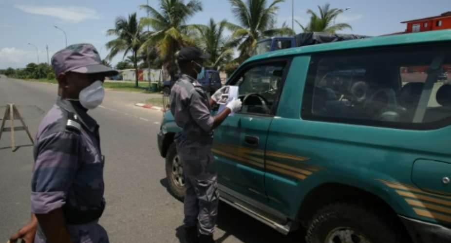 Police set up road blocks to check people had the proper authorization to be out.  By Steeve JORDAN AFP