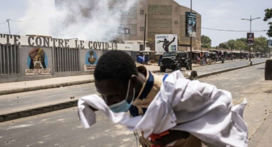 Police used tear gas to disperse rock-throwing protesters in central Dakar.  By JOHN WESSELS AFP