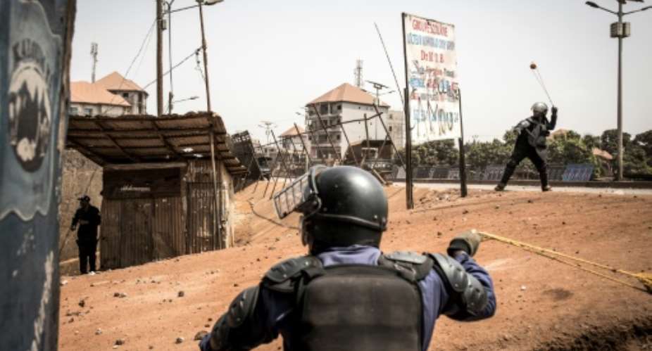 Policemen fired slingshots as an anti-Conde demonstration in Conakry last month turned violent.  By JOHN WESSELS AFP