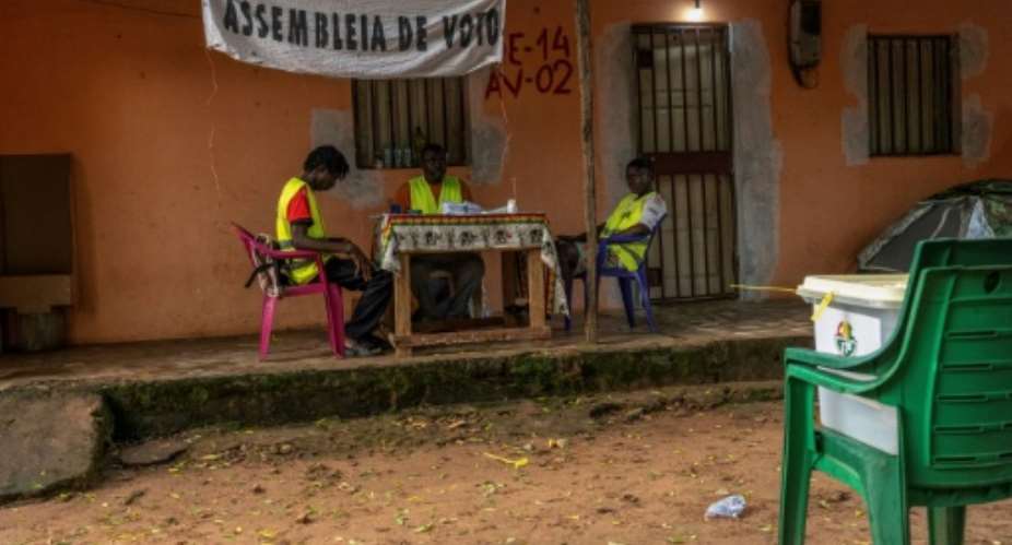 Poll workers wait for voters during Guinea-Bissaus constitutional referendum.  By Samba BALDE (AFP/File)