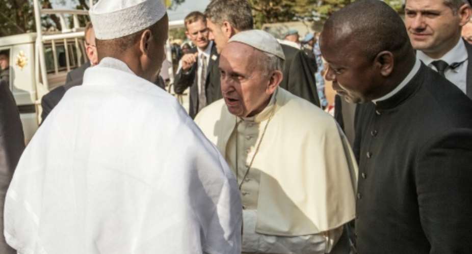 Pope Francis C is greet by Central Mosque Nehedid Tidjani L, upon his arrival in the PK5 neighborhood of Bangui, on November 30, 2015.  By Gianluigi Guercia AFP