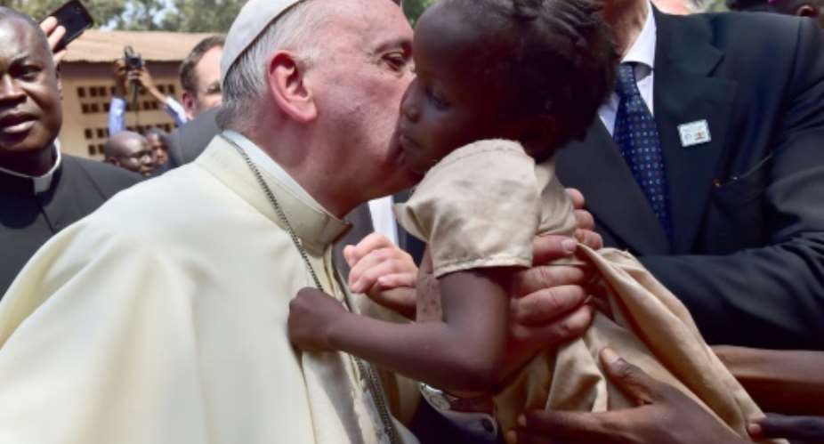 Pope Francis meets children in a refugee camp on November 29, 2015 in Bangui.  By Giuseppe Cacace AFP