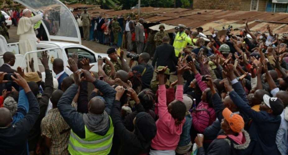 Wild singing and ululating erupted as Pope Francis' arrived in Kangemi, his popemobile weaving through a sea of tin-roofed homes.  By Carl de Souza AFP