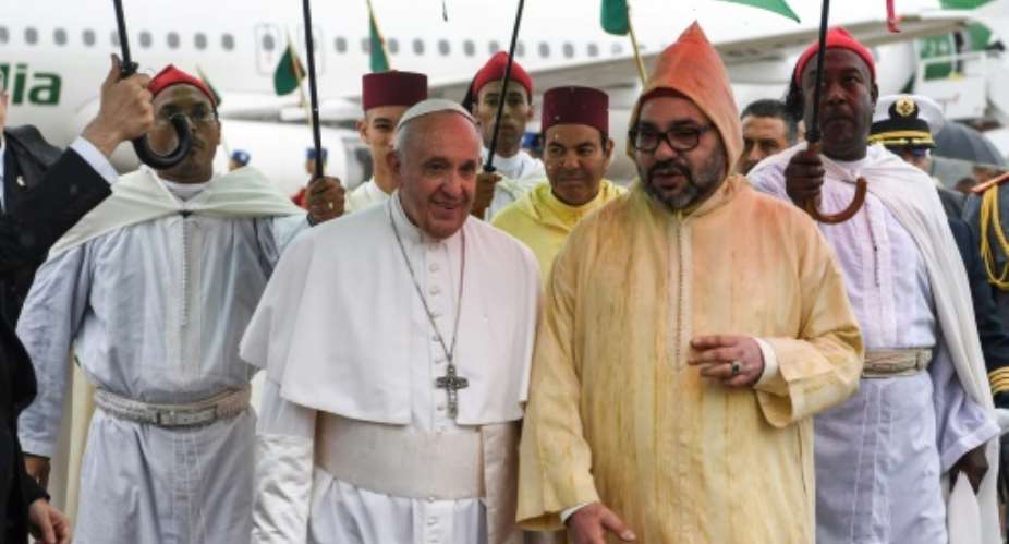 Pope Francis C-L is received by Morocco's King Mohammed VI C-R on arrival in Rabat.  By FADEL SENNA POOLAFP