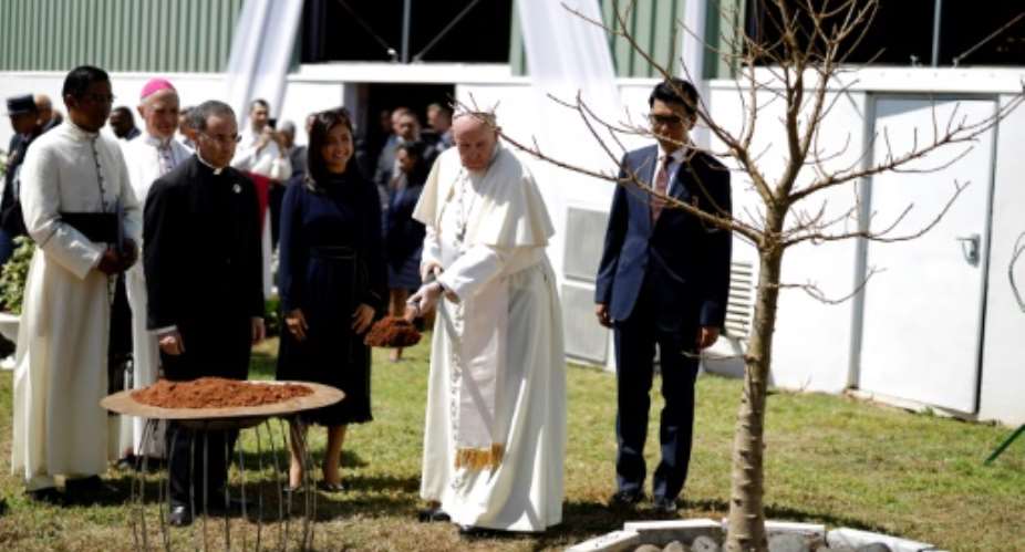 Pope Francis planted a baobab tree with Madagascar President Andry Rajoelina at the presidential palace in Antananarivo.  By MARCO LONGARI AFP