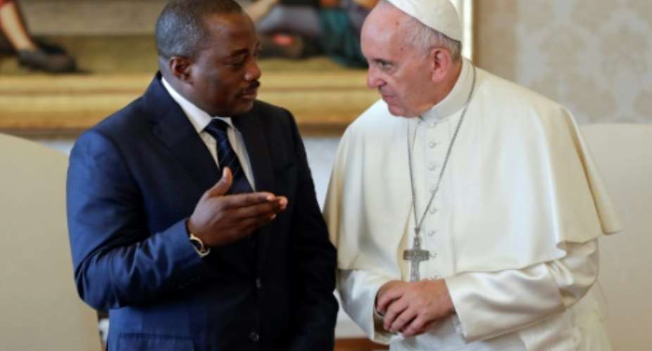 Pope Francis (R) talks with Democratic Republic of Congos President Joseph Kabila during a private audience in the pontiffs studio, at the Vatican in 2016.  By ANDREW MEDICHINI (POOL/AFP/File)