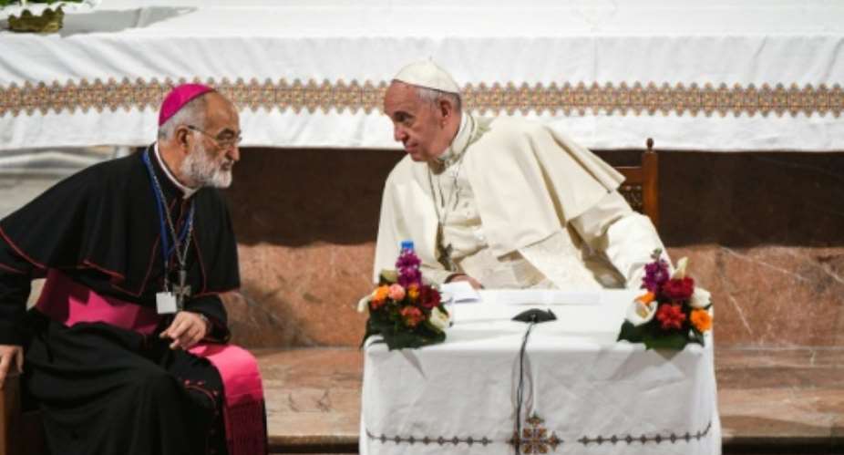 Pope Francis speaks with the Cardinal Cristobal Lopez Romero (left) during his papal visit to Morocco in 2019.  By FADEL SENNA (AFP/File)