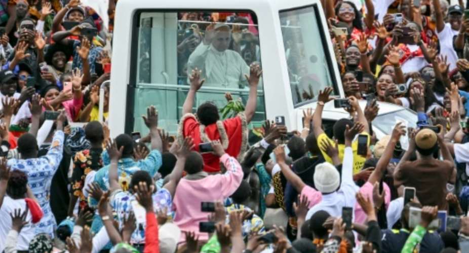 Pope Leo XIV blessed the crowd from a popemobile with bulletproof windows.  By Alberto PIZZOLI (AFP)
