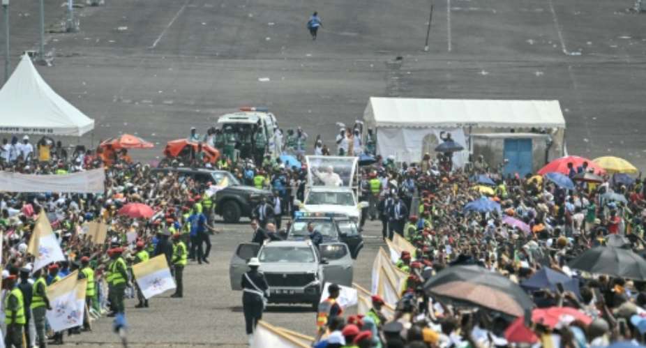 Pope Leo XIV (C) heads to the port city of Douala for a huge open-air mass on the third day of his Cameroon tour.  By Alberto PIZZOLI (AFP)